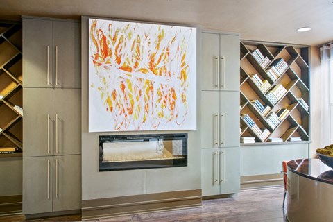 a painting hangs above a fireplace in a living room